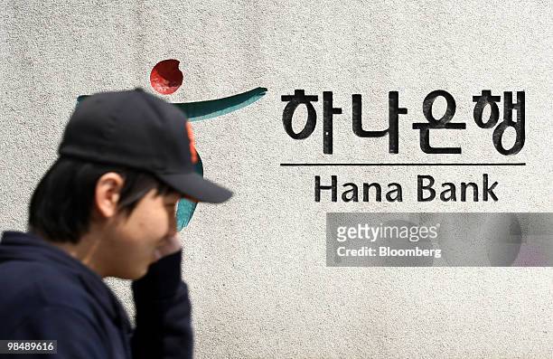Man walks past the the Hana Bank headquarters in Seoul, South Korea, on Friday, April 16, 2010. Hana Financial Group Inc. Is expected to announce...