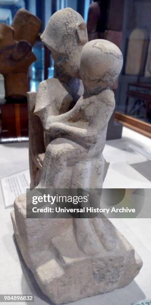 Statue of Pharaoh Akhenaten kissing one of his daughters. 18th dynasty. Egyptian.