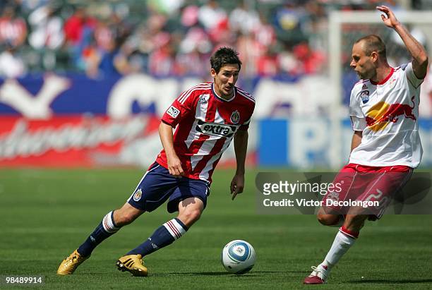 Sacha Kljestan of Chivas USA paces the ball on the attack against Joel Lindpere of the New York Red Bulls during their MLS match at the Home Depot...