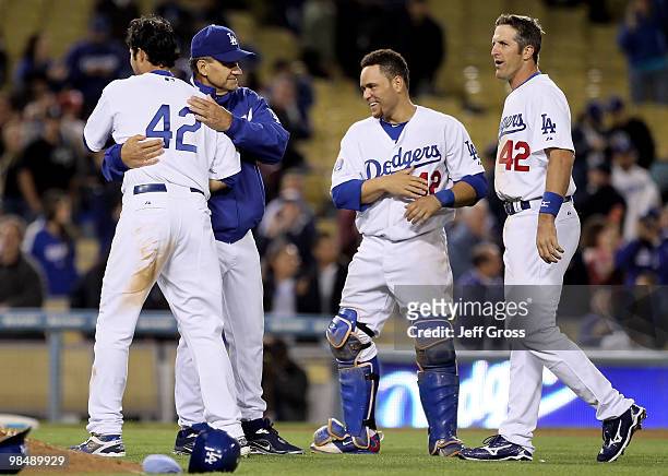 Andre Ethier of the Los Angeles Dodgers is congratulated by manager Joe Torre as Russell Martin and Casey Blake look on after Ethier drove in the...