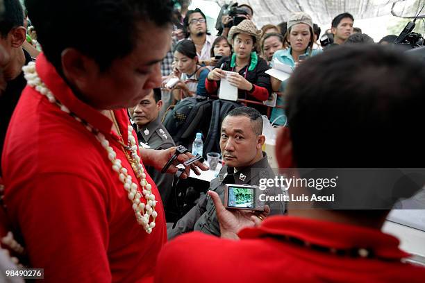 Thai policemen are seen at Bangkok commercial district, after being detained by Red shirt supporters during their foiled arrest attempt of Arisman...