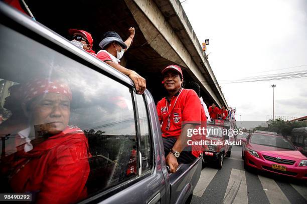 Red Shirt supporters celebrate after the Thai forces foiled arrest attempt of Arisman Pongruangrong an anti-government protest leader who escaped by...