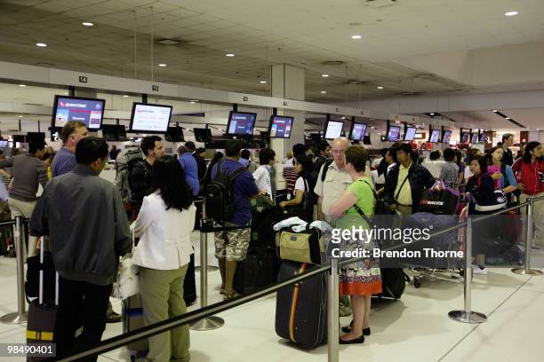 Passengers queue for a special flight bound for Singapore as flights are delayed and cancelled following the eruption of iceland's Eyjafjallajokull...