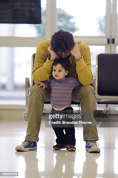Passenger and his son show signs of frustration as flights are delayed and cancelled following the eruption of iceland's Eyjafjallajokull volcano, at...