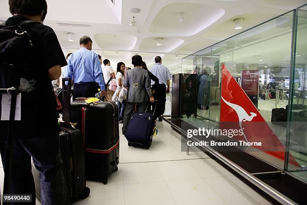 Passengers queue for a special flight bound for Singapore as flights are delayed and cancelled following the eruption of iceland's Eyjafjallajokull...