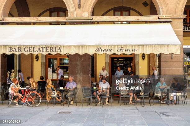 Saluzzo in the province of Cuneo, Piedmont region. Cafe terrace in the town centre.