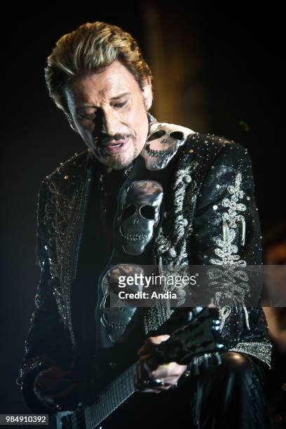 Johnny Hallyday performing live , during his tour called 'Flashback' Close-up portrait and earpiece.