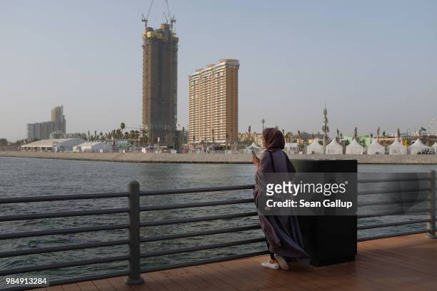 Young woman stands on a fishing pier on the Corniche waterfront on June 23, 2018 in Jeddah, Saudi Arabia. The Saudi government, under Crown Prince...