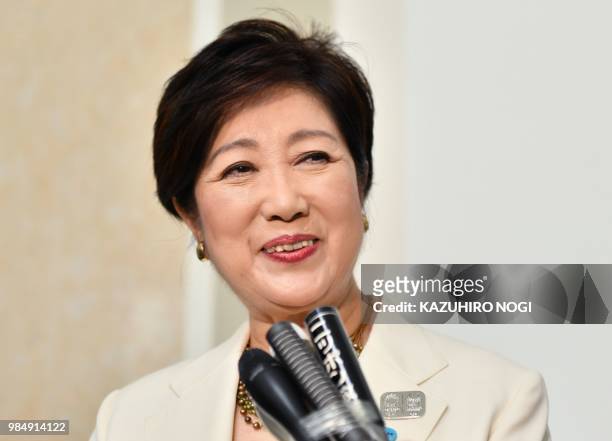 Tokyo governor Yuriko Koike reacts as she answers questions during a press briefing after a session of the metropolitan assembly in Tokyo on June 27,...