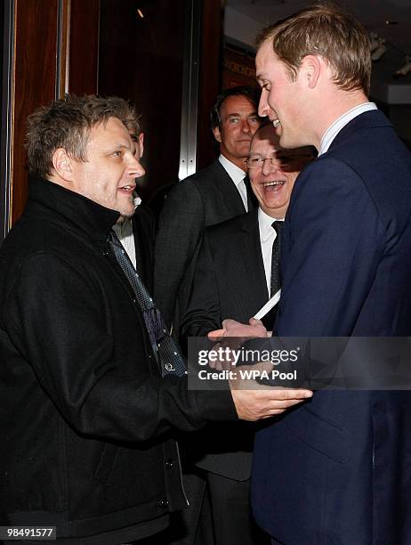 Prince William greets British celebrity portrait photographer Rankin at a royal charity gala for Crisis, 'A Positive View' at Christie's auction...