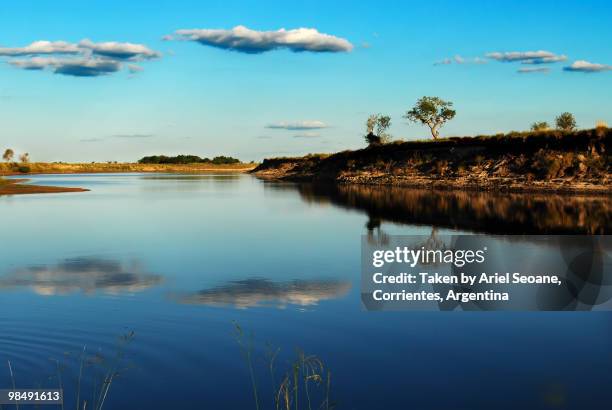 clouds reflexion on a river - reflexion stock pictures, royalty-free photos & images