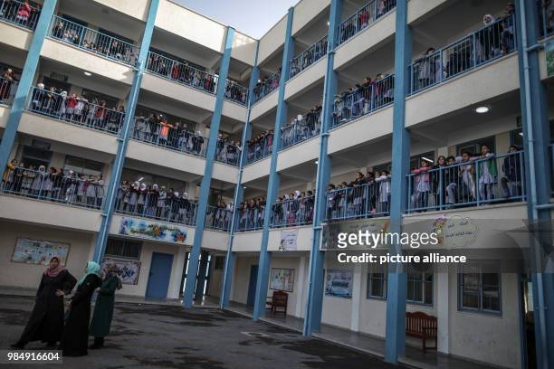 Palestinian school girls watch a press conference by UNRWA Commissioner General Pierre Krahenbuhl during his visit to an UNRWA school in Gaza City,...
