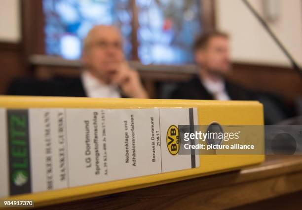 Yellow folder showing the Borussia Dortmund logo lies on a table at a trial in the court of Dortmund, Germany, 22 January 2018. A 28-year-old man is...