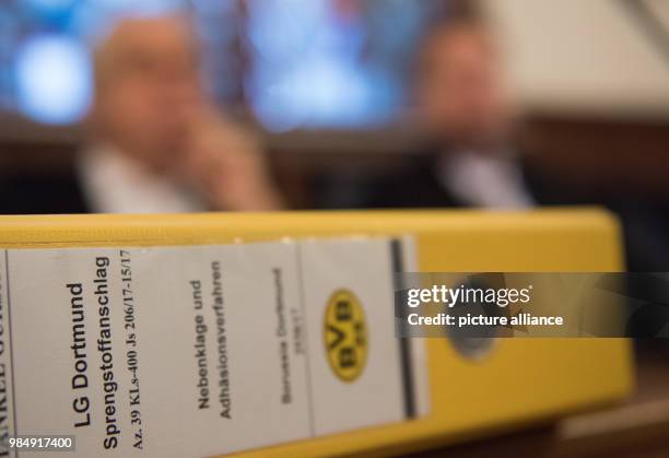 Yellow folder showing the Borussia Dortmund logo lies on a table at a trial in the court of Dortmund, Germany, 22 January 2018. A 28-year-old man is...