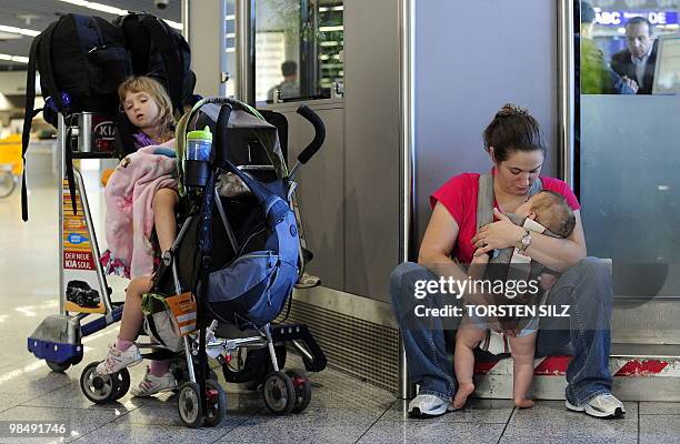 Woman and three children wait for the resumption of air travel on April 16, 2010 at the airport in Frankfurt/M. Flights at Frankfurt airport, the...