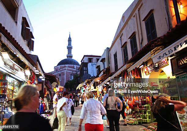 Tourists visiting the Unesco world heritage medieval city of Rhodes with restaurants and shops on July 16, 2009 in Rhodes, Greece. Rhodes is the...