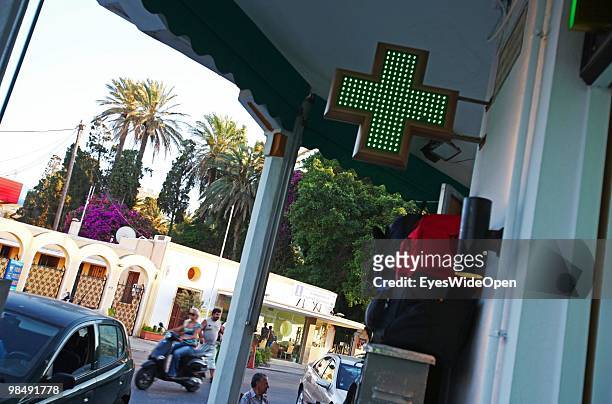 Green cross sign of a pharmacy on July 16, 2009 in Rhodes, Greece. Rhodes is the largest of the Greek Dodecanes Islands.