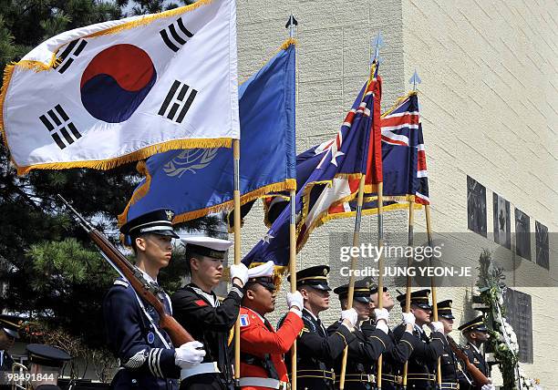 United Nations honor guards hold flags while veterans from the British Commonwealth countries, who fought alongside South Korea during the 1950-53...