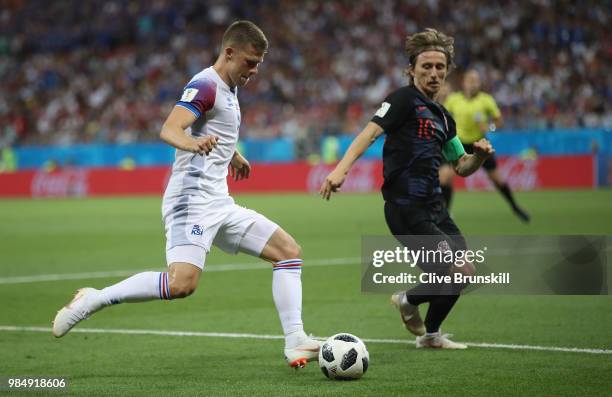 Johann Gudmundsson of Iceland in action with Luka Modric of Croatia during the 2018 FIFA World Cup Russia group D match between Iceland and Croatia...