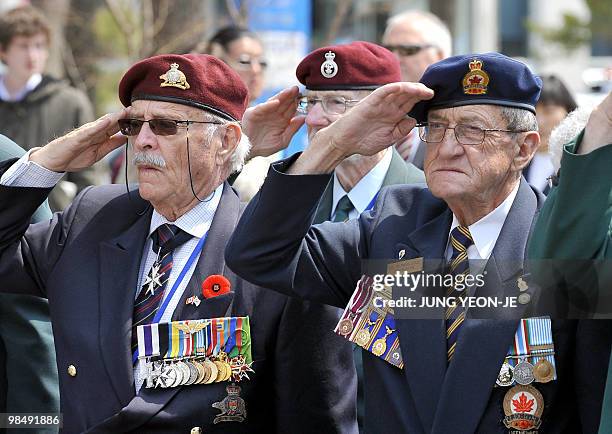 Veterans from Canada, who fought alongside South Korea during the 1950-53 Korean War, saluite as they visit a participation memorial in Gapyeong, 55...