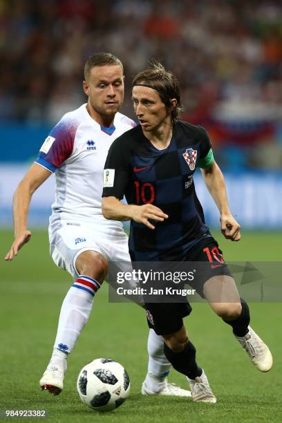 Luka Modric of Croatia controls the ball from Sverrir Ingason of Iceland during the 2018 FIFA World Cup Russia group D match between Iceland and...