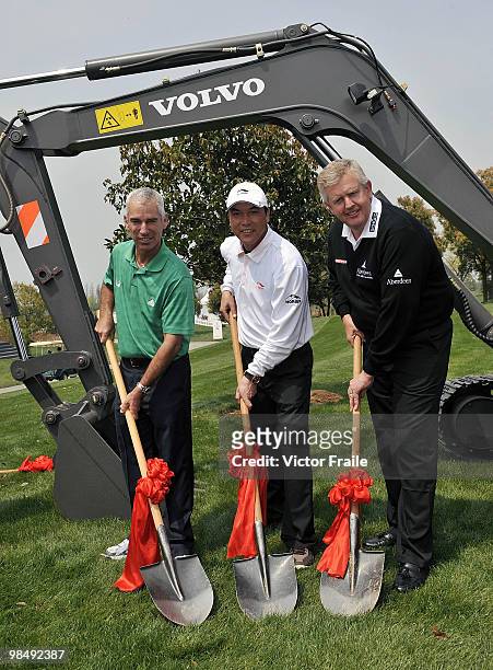 Corey Pavin of USA, Zhang Lian-wei of China and Colin Montgomerie of Scotland pose for the media after planting a tree during the Round Two of the...