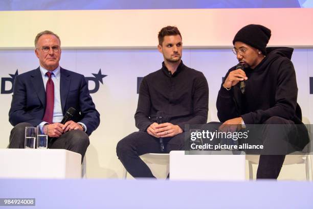 Karl-Heinz Rummenigge , CEO of FC Bayern Munich, Sven Ulreich, goalkeeper of Bayern Munich and Jerome Boateng, player of Bayern Munich sit on the...