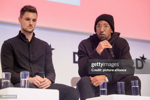 Goalkeeper of Bayern Munich and Jerome Boateng, player of Bayern Munich sit on the podium during the innovation conference Digital-Life-Design within...