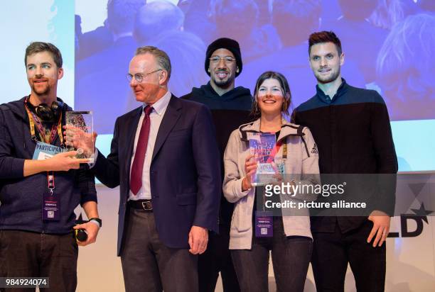Christoph Hamsen and Magdalena Juengst freom the winner team of FC BAyern HackDays stand on the podium together with Karl-Heinz Rummenigge , CEO of...