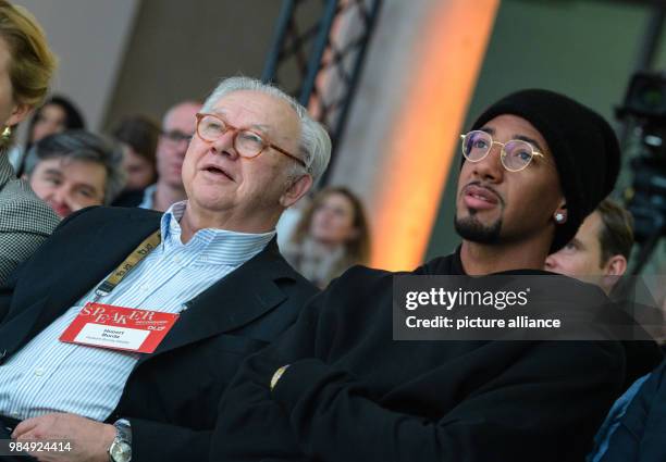 Jerome Boateng R), player of FC Bayern Munich, sits next to publisher Hubert Burda in the audience at the innovation conference Digital-Life-Design...