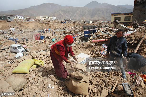 Locals clear rubble from collapsed houses following a strong earthquake on April 16 near Golmud, China. It is currently reported that 791 people have...