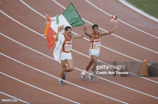 Mexican racewalkers Ernesto Canto and Raul Gonzalez of the Mexico team celebrate with the national flag after finishing in first place and 2nd place...
