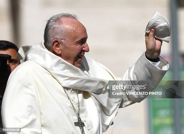 Pope Francis holds his Zucchetto as he arrives in St. Peters square at the Vatican for his weekly general audience on June 27, 2018
