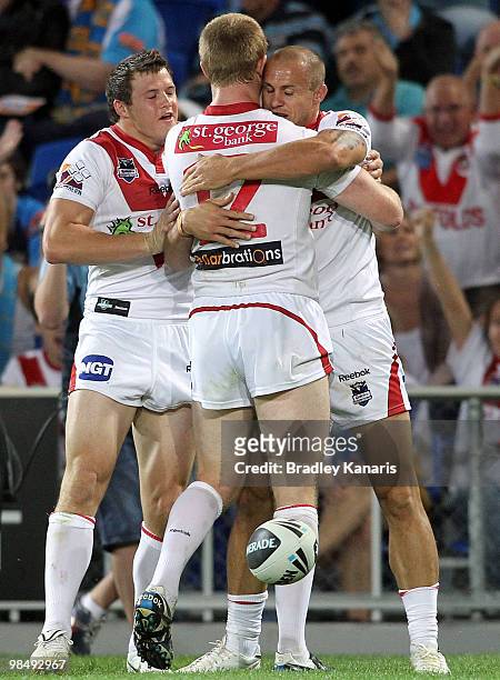 Matt Cooper of the Dragons celebrates with team mates after scoring a try during the round six NRL match between the Gold Coast Titans and the St...