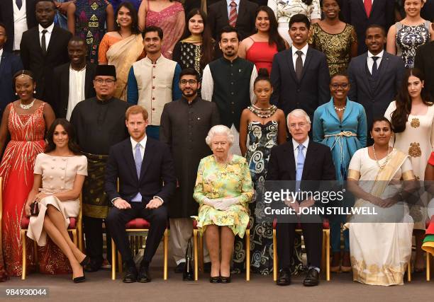 Meghan, Duchess of Sussex, Britain's Prince Harry, Duke of Sussex and Britain's Queen Elizabeth II and former Prime Minister John Major pose for a...