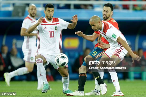 Younes Belhanda of Morocco , Sergio Busquets of Spain , Karim El Ahmadi of Morocco during the World Cup match between Spain v Morocco at the...