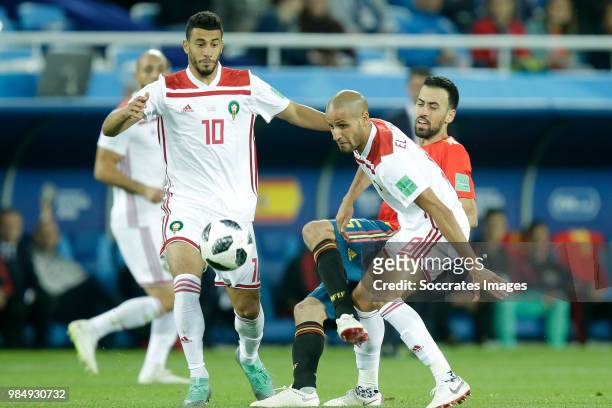 Younes Belhanda of Morocco , Sergio Busquets of Spain , Karim El Ahmadi of Morocco during the World Cup match between Spain v Morocco at the...