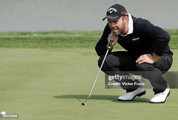 Christian Nilsson of Sweden lines up a putt on the 9th hole during the Round Two of the Volvo China Open on April 16, 2010 in Suzhou, China.