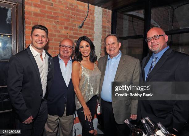 Jesse Bongiovi, Danielle Staub, President of The Melting Pot Restaurants Mike Lester and Red Bank Mayor Pat Menna attend The Melting Pot of Red Bank...