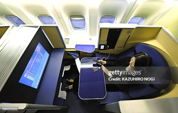 Seats of the first class in the new passenger plane Boeing 777-300ER of Japan's All Nippon Airways are opened for the press at an ANA hungar in...