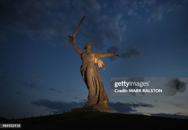 This picture taken on June 26, 2018 shows people visiting the Motherland Calls statue at the Mamayev Kurgan World War II memorial complex in...