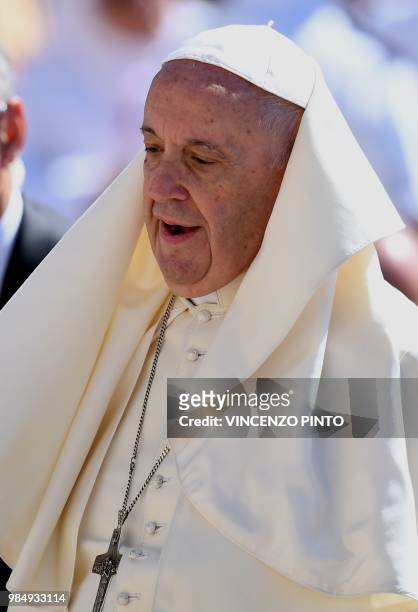 Pope Francis looks on he arrives at the St. Peters square at the Vatican for his weekly general audience on June 27, 2018.