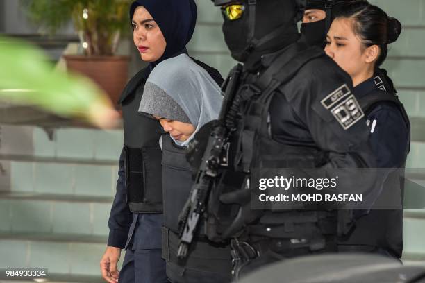 Indonesian national Siti Aisyah is escorted by Malaysian police after a court session for her trial at the Shah Alam High Court in Shah Alam, outside...