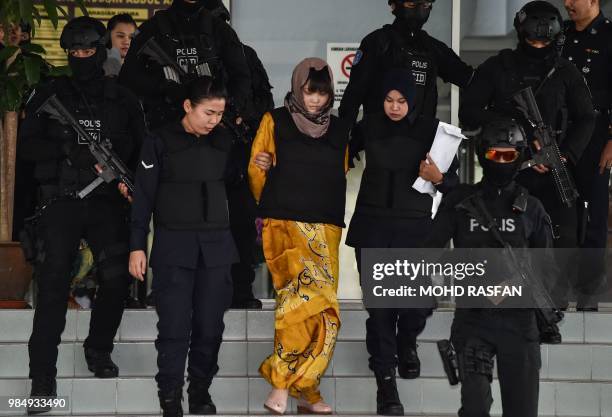 Vietnamese national Doan Thi Huong is escorted by Malaysian police after a court session for her trial at the Shah Alam High Court in Shah Alam,...