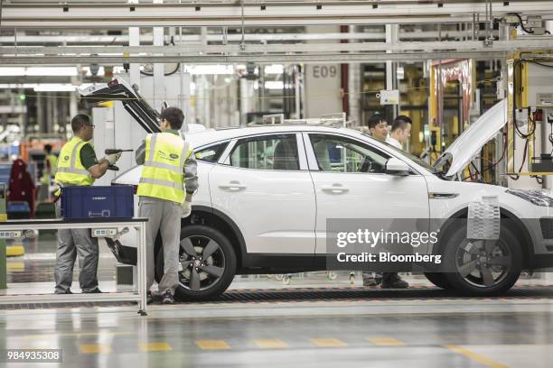 Employees assemble a Jaguar E-Pace compact sport utility vehicle on the production line at the second phase of the Chery Jaguar Land Rover Automotive...