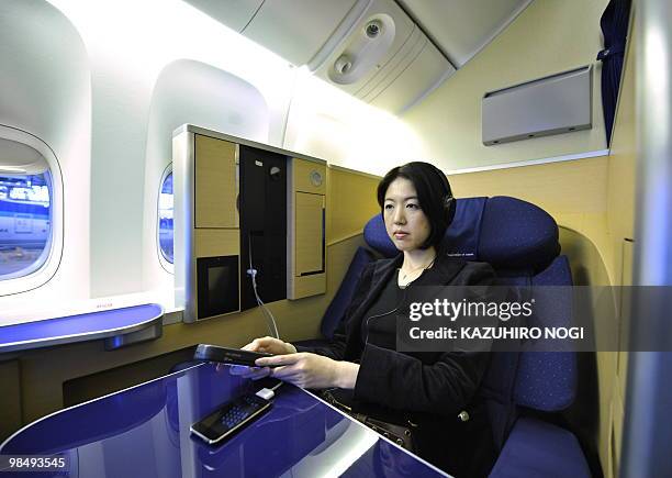 Seats of the first class in the new passenger plane Boeing 777-300ER of Japan's All Nippon Airways are opened for the press at an ANA hungar in...