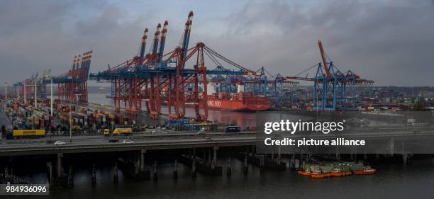 Container freight from the Hamburg Sued shipping company lying by the container bridge cranes of the Burchardkai by the A7 motorway in Hamburg,...