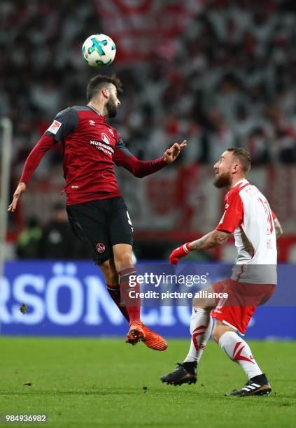 Nuremberg's Mikael Ishak and Jahn Regensburg's Marvin Knoll vie for the ball during the German 2nd division Bundesliga soccer match between 1. FC...