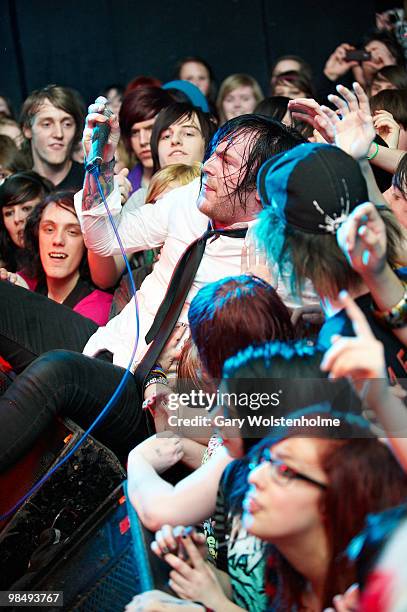 Dennis Lee of Alesana stage dives into the crowd while performing at Cockpit on April 13, 2010 in Leeds, England.