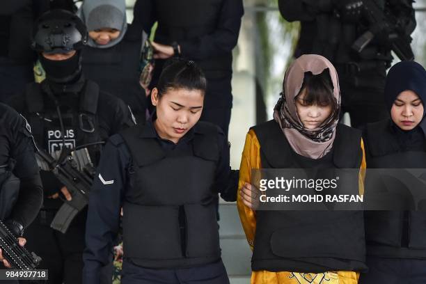 Vietnamese national Doan Thi Huong and Indonesian national Siti Aisyah are escorted by Malaysian police after a court session for their trial at the...